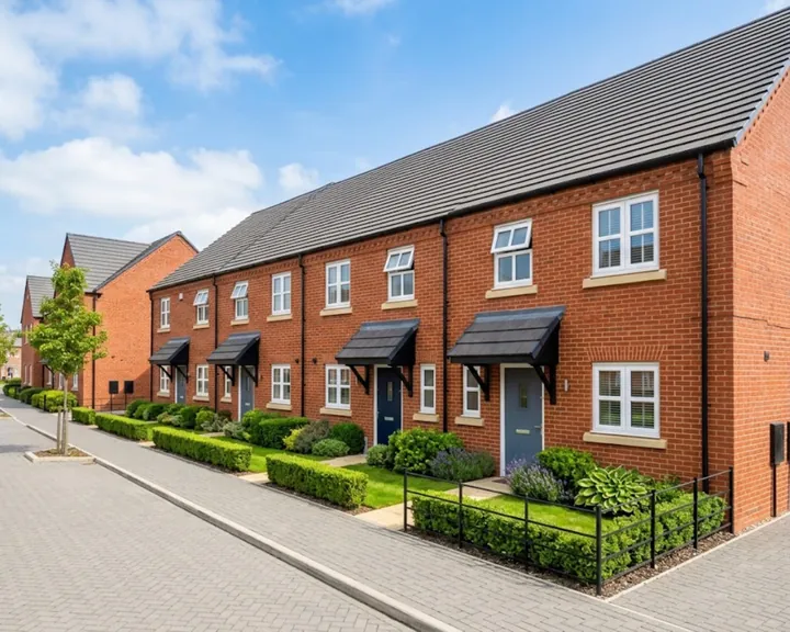 Row of modern red-brick terraced houses with small front gardens